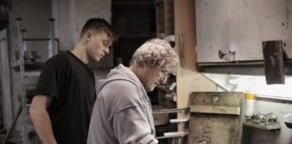 master showing apprentice how handling detail