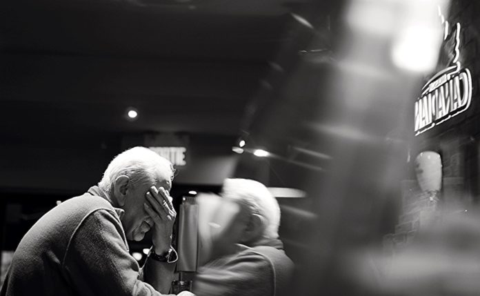 white haired man in jacket with watch